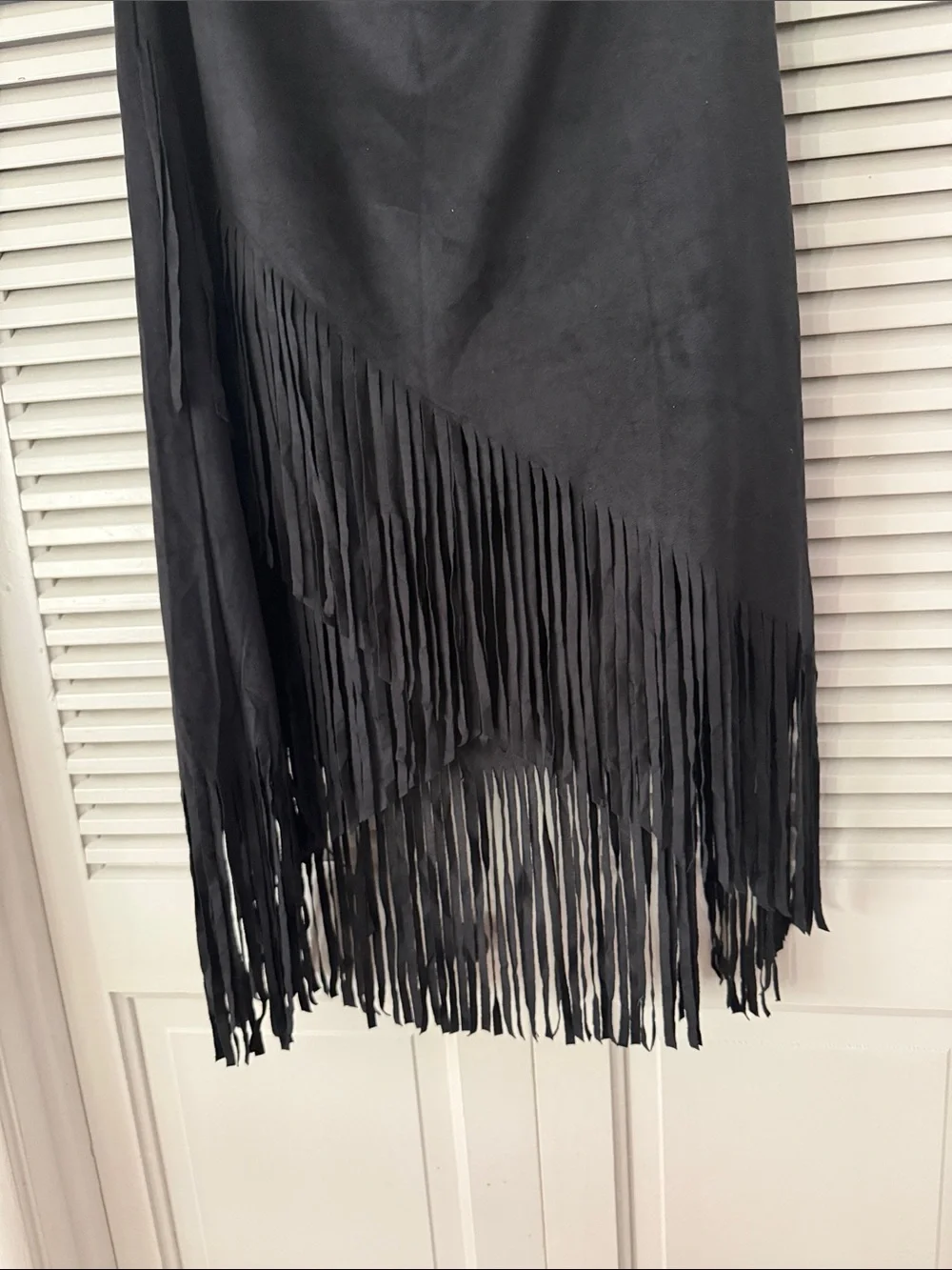 Sleek black skirt with long fringe hem. Soft suede-like texture. Hobo